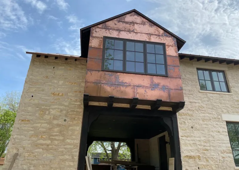 Copper metal panel facade on a stone building for Skylight Installation in Norwalk
