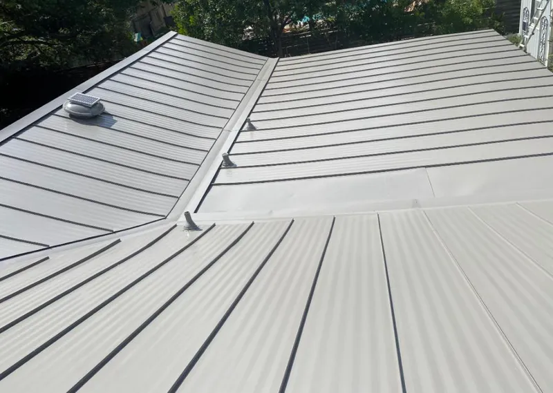 Solar attic fan installed on a metal roof for Roof Ventilation in Norwalk